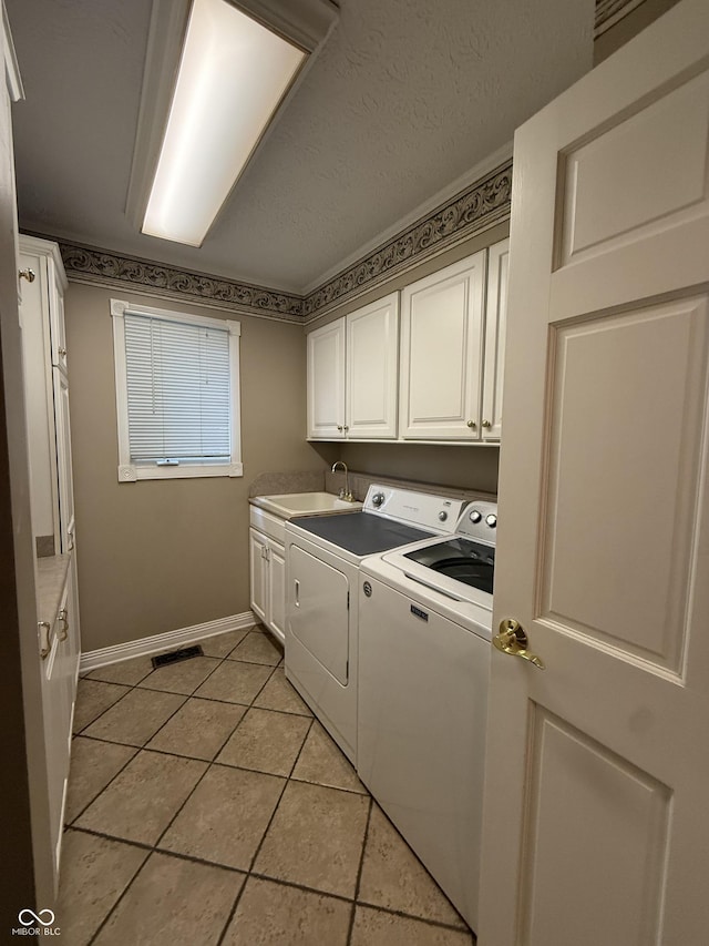 6609 N Tuxedo Ln, Indianapolis, IN 46220 - washroom with separate washer and dryer, baseboards, cabinet space, and light tile patterned floors