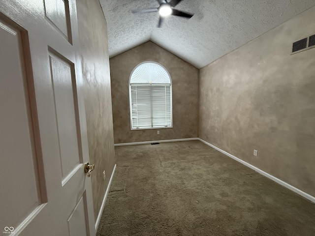 6609 N Tuxedo Ln, Indianapolis, IN 46220 - unfurnished room with ceiling fan, vaulted ceiling, carpet, a textured ceiling, and baseboards