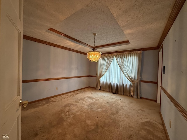 6609 N Tuxedo Ln, Indianapolis, IN 46220 - unfurnished room featuring a textured ceiling, a chandelier, carpet flooring, a tray ceiling, and ornamental molding