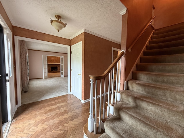 6609 N Tuxedo Ln, Indianapolis, IN 46220 - stairway featuring baseboards, a textured ceiling, and crown molding