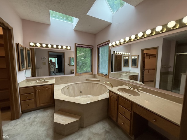 6609 N Tuxedo Ln, Indianapolis, IN 46220 - bathroom featuring a skylight, a jetted tub, vanity, a shower stall, and a towering ceiling