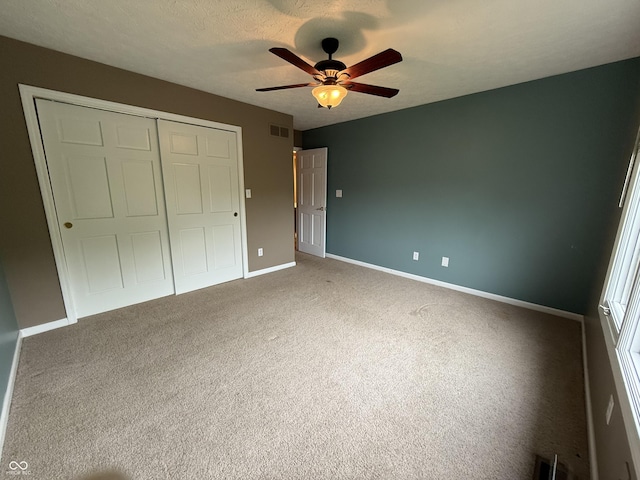 6609 N Tuxedo Ln, Indianapolis, IN 46220 - unfurnished bedroom with a closet, baseboards, carpet, and a ceiling fan