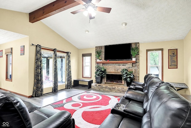 926 Brookside Ln, Plainfield, IN 46168 - living room with wood finished floors, a ceiling fan, baseboards, a fireplace, and a textured ceiling