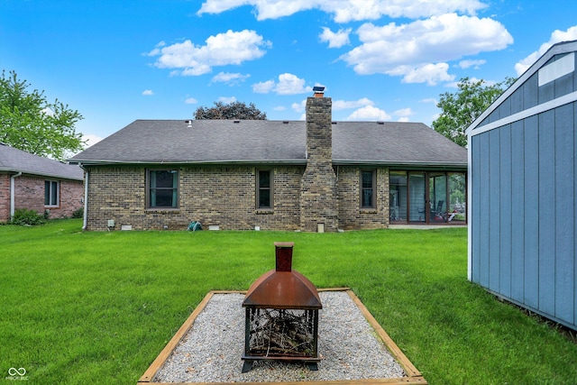 926 Brookside Ln, Plainfield, IN 46168 - rear view of house featuring an outdoor fire pit, brick siding, a lawn, a chimney, and a shingled roof