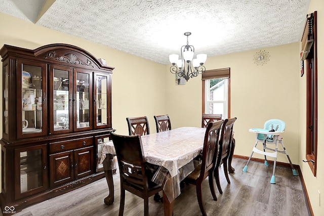 926 Brookside Ln, Plainfield, IN 46168 - dining area with a chandelier, wood finished floors, a textured ceiling, and baseboards