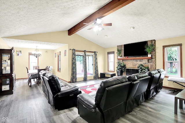 926 Brookside Ln, Plainfield, IN 46168 - living room with light wood finished floors, a chandelier, a textured ceiling, a fireplace, and a ceiling fan