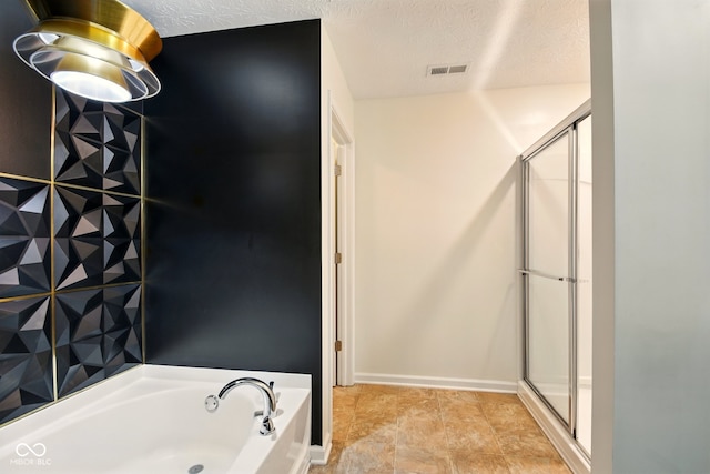 1454 Silver Pine Ln, Sheridan, IN 46069 - bathroom featuring a bath, a stall shower, and a textured ceiling