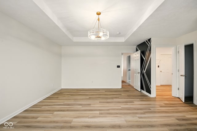 1454 Silver Pine Ln, Sheridan, IN 46069 - spare room with light wood-style floors, baseboards, and a tray ceiling