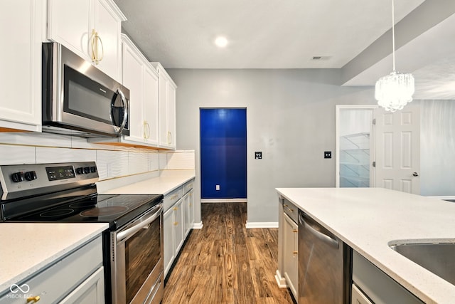 1454 Silver Pine Ln, Sheridan, IN 46069 - kitchen featuring appliances with stainless steel finishes, dark wood finished floors, baseboards, backsplash, and white cabinetry