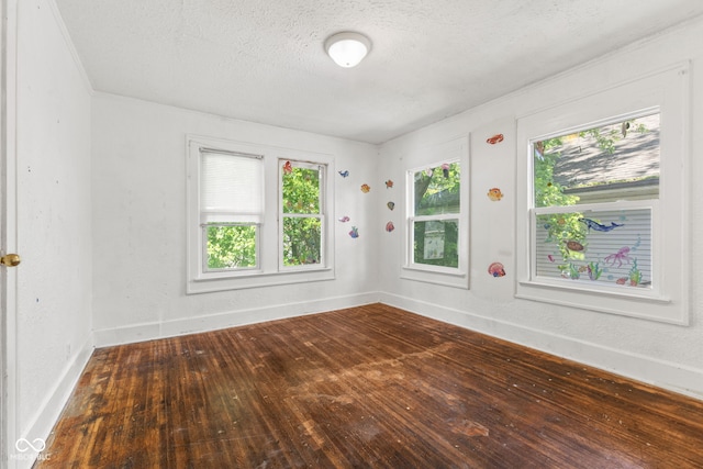 3134 N College Ave, Indianapolis, IN 46205 - empty room with dark wood-type flooring, a textured ceiling, and baseboards