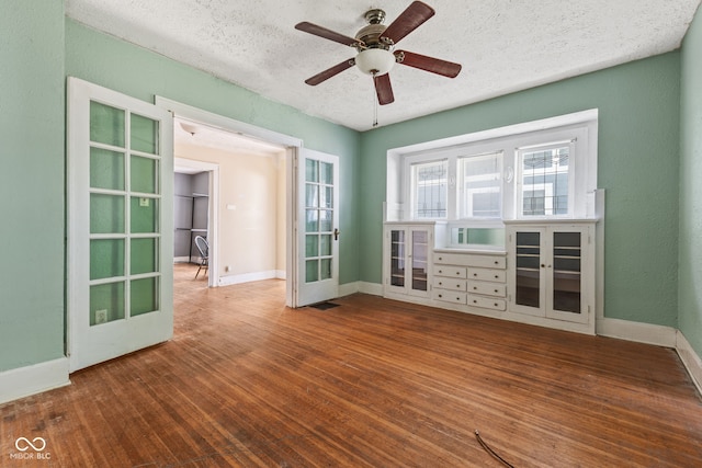 3134 N College Ave, Indianapolis, IN 46205 - empty room featuring baseboards, a textured ceiling, wood finished floors, and a ceiling fan