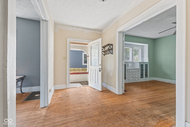 3134 N College Ave, Indianapolis, IN 46205 - hall with a textured ceiling, wood finished floors, and baseboards