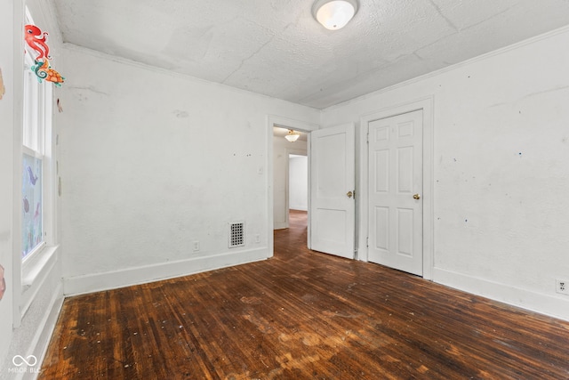 3134 N College Ave, Indianapolis, IN 46205 - unfurnished room with hardwood / wood-style floors, a textured ceiling, baseboards, and crown molding