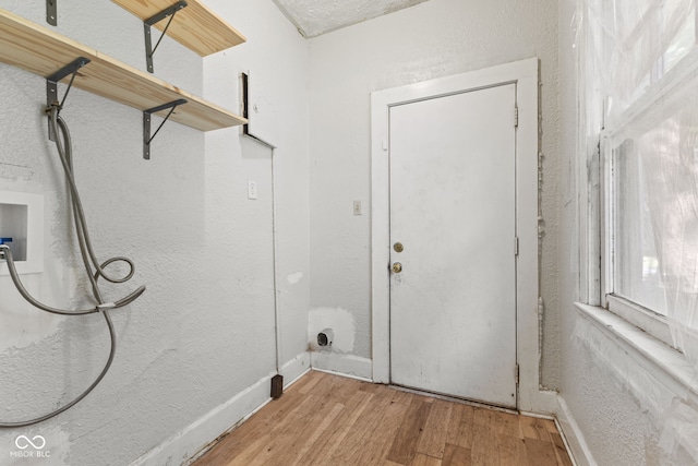 3134 N College Ave, Indianapolis, IN 46205 - washroom featuring washer hookup, wood finished floors, baseboards, and a textured wall