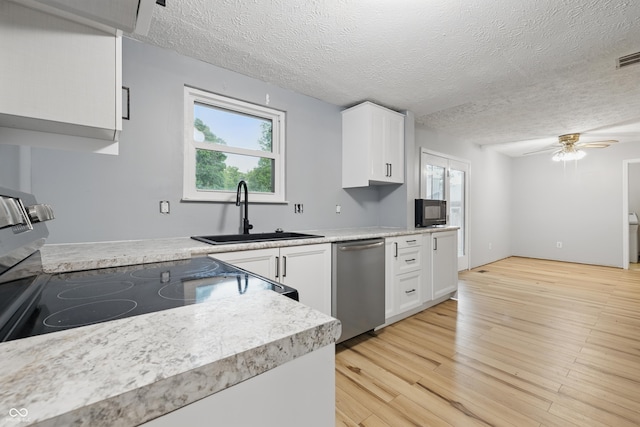 1826 Shorter Dr, Indianapolis, IN 46214 - kitchen with a sink, stainless steel appliances, a textured ceiling, healthy amount of natural light, and white cabinets
