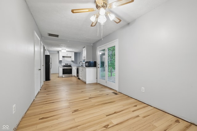 1826 Shorter Dr, Indianapolis, IN 46214 - unfurnished living room with light wood finished floors, a sink, a textured ceiling, and ceiling fan