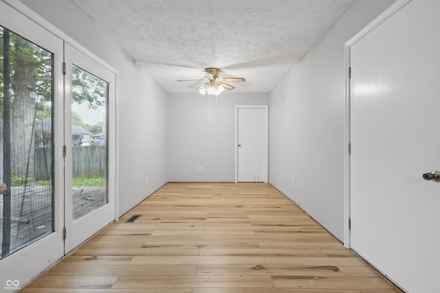 1826 Shorter Dr, Indianapolis, IN 46214 - spare room featuring light wood-type flooring, a textured ceiling, and ceiling fan