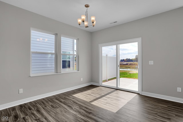 611 Bridgeman Rd, Avon, IN 46123 - spare room with a chandelier, dark wood-style flooring, and a water view