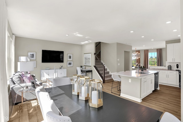 6702 Halsey St, Zionsville, IN 46077 - dining area with stairway, a chandelier, recessed lighting, and wood finished floors