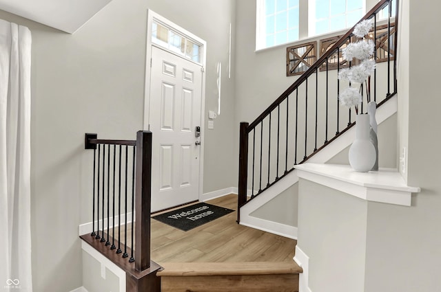 6702 Halsey St, Zionsville, IN 46077 - entryway featuring wood finished floors, baseboards, and stairway