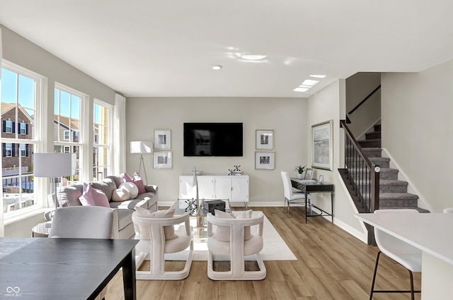6702 Halsey St, Zionsville, IN 46077 - living area featuring light wood-style floors, stairs, and baseboards