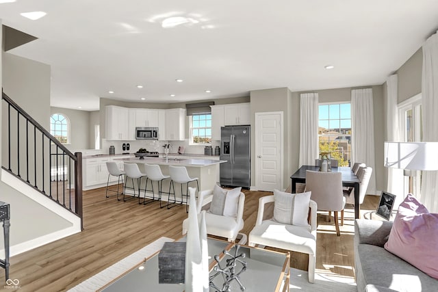 6702 Halsey St, Zionsville, IN 46077 - living area featuring stairway, light wood-type flooring, and recessed lighting