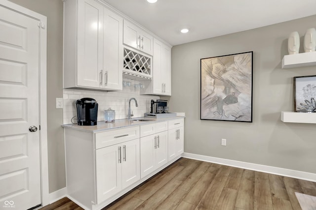 6702 Halsey St, Zionsville, IN 46077 - indoor wet bar with baseboards, backsplash, light wood-type flooring, and recessed lighting