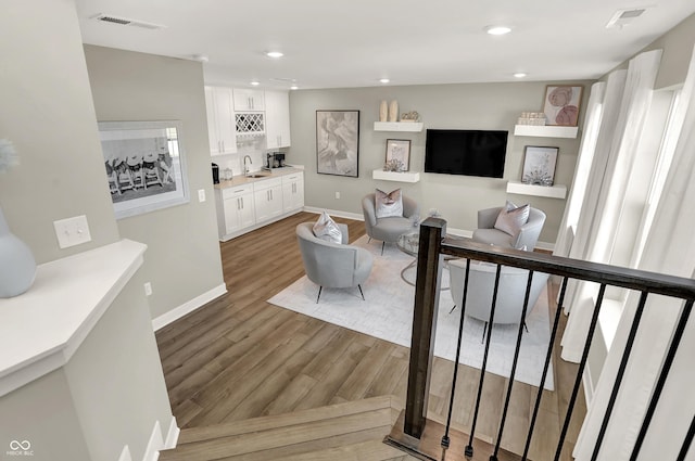 6702 Halsey St, Zionsville, IN 46077 - living room featuring wood finished floors, baseboards, and recessed lighting