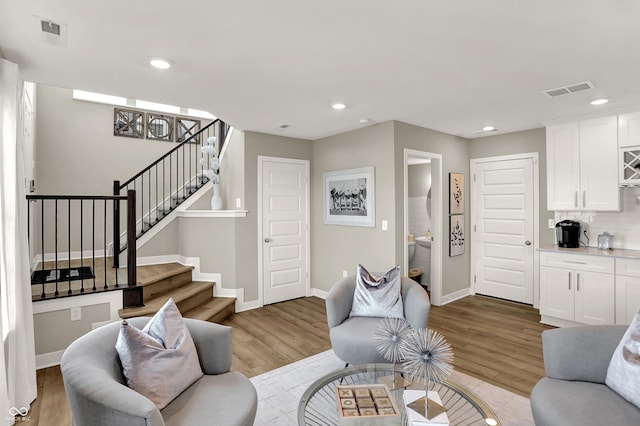 6702 Halsey St, Zionsville, IN 46077 - living area with stairs, light wood-style flooring, baseboards, and recessed lighting