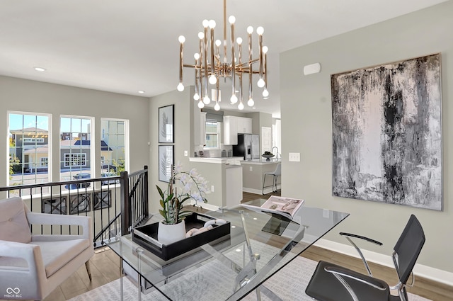 6702 Halsey St, Zionsville, IN 46077 - dining room with plenty of natural light, a chandelier, baseboards, recessed lighting, and wood finished floors