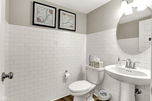 6702 Halsey St, Zionsville, IN 46077 - bathroom featuring toilet, tile walls, wood finished floors, and a wainscoted wall