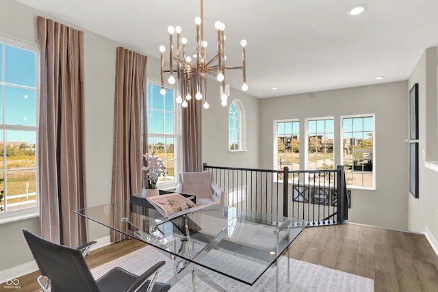6702 Halsey St, Zionsville, IN 46077 - dining area with a chandelier, wood finished floors, recessed lighting, and baseboards