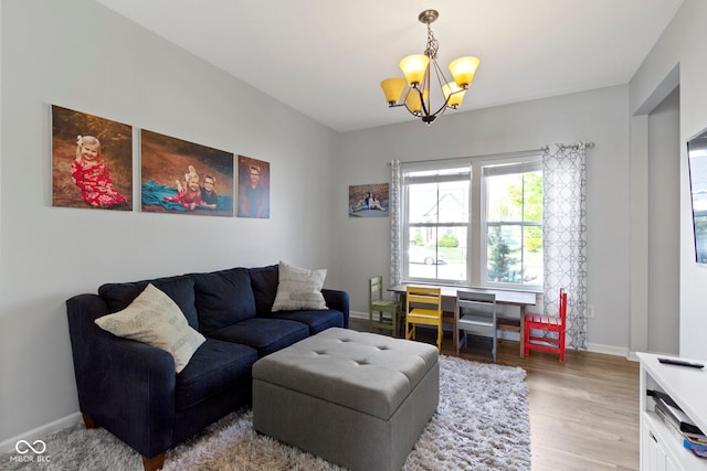 13485 Mancroft Dr, Fishers, IN 46037 - living room with a chandelier, baseboards, and wood finished floors