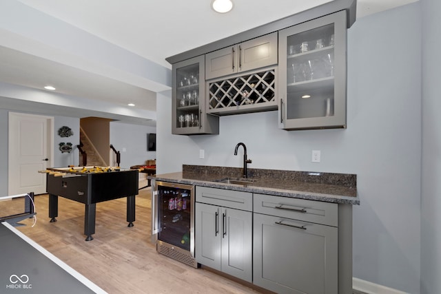 13485 Mancroft Dr, Fishers, IN 46037 - indoor wet bar with wine cooler, stairs, light wood-style floors, recessed lighting, and baseboards
