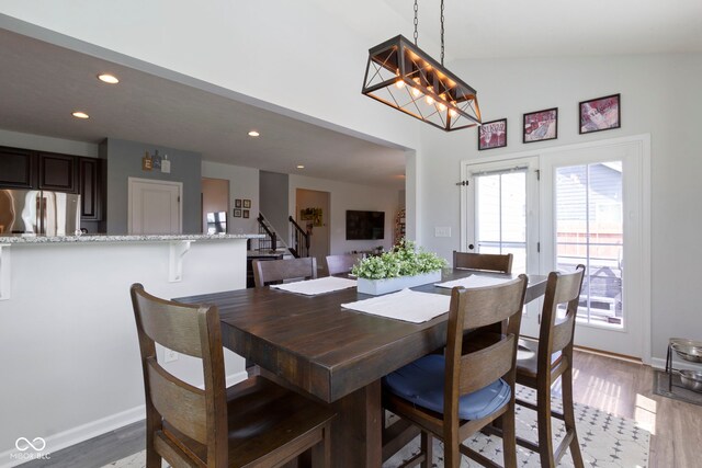 13485 Mancroft Dr, Fishers, IN 46037 - dining space featuring recessed lighting, light wood-style flooring, stairway, baseboards, and high vaulted ceiling