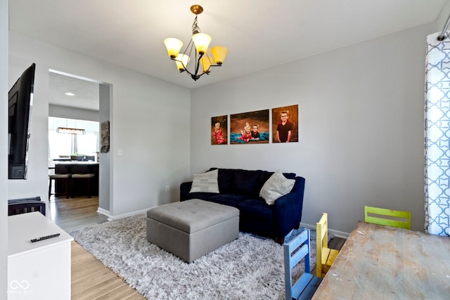 13485 Mancroft Dr, Fishers, IN 46037 - living area with a chandelier, wood finished floors, and baseboards