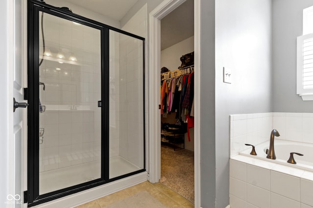 13485 Mancroft Dr, Fishers, IN 46037 - full bathroom featuring a shower stall, a bath, tile patterned flooring, and a spacious closet