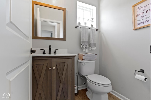 13485 Mancroft Dr, Fishers, IN 46037 - half bathroom with vanity, toilet, wood finished floors, and baseboards
