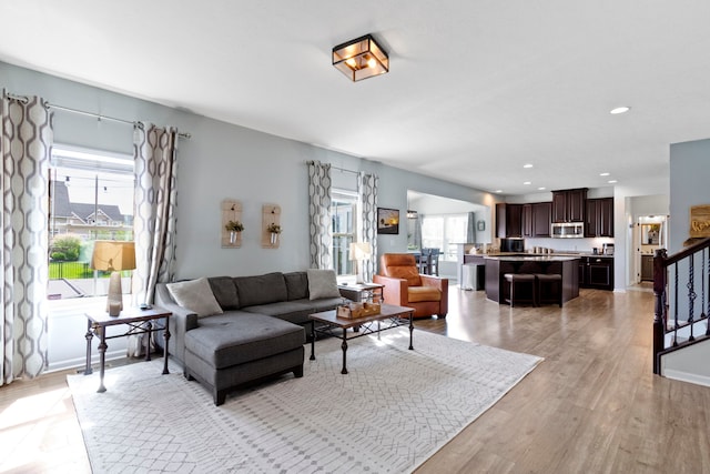 13485 Mancroft Dr, Fishers, IN 46037 - living room featuring light wood-type flooring, stairs, and recessed lighting