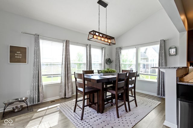 13485 Mancroft Dr, Fishers, IN 46037 - dining area featuring vaulted ceiling, baseboards, and light wood-style flooring