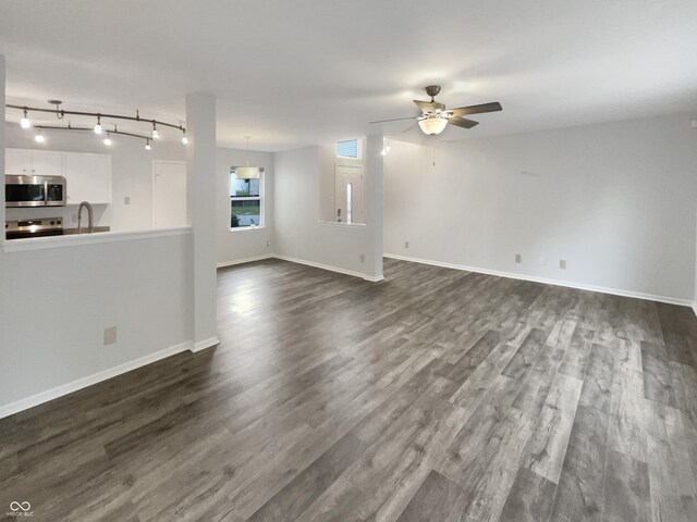15110 Fawn Hollow Ln, Noblesville, IN 46060 - unfurnished living room featuring a ceiling fan, dark wood finished floors, a sink, and baseboards