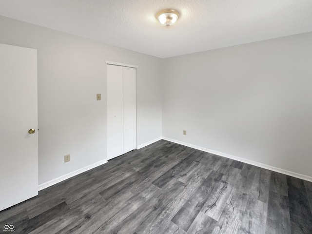 15110 Fawn Hollow Ln, Noblesville, IN 46060 - empty room featuring dark wood finished floors and baseboards