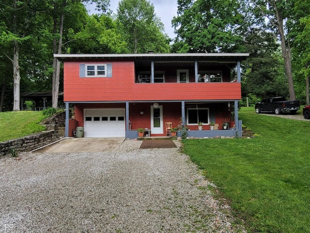 1305 Albin Pond Rd, Greencastle, IN 46135 - view of front of home with gravel driveway, a front lawn, a garage, and covered porch