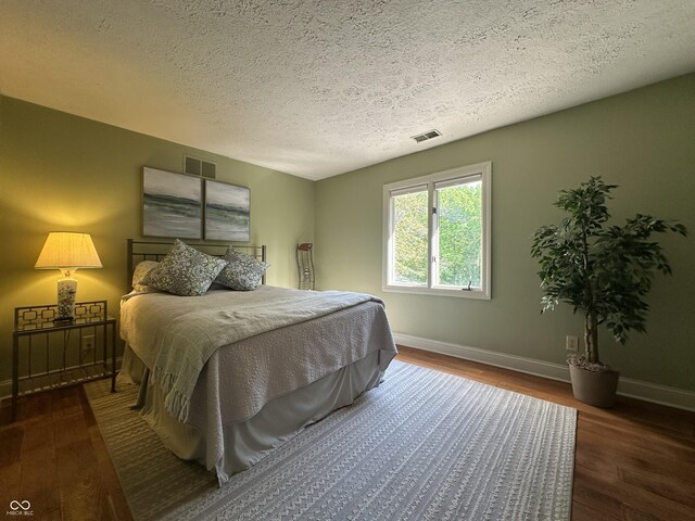 2034 Dubois Rd, Spencer, IN 47460 - bedroom with wood finished floors, baseboards, and a textured ceiling
