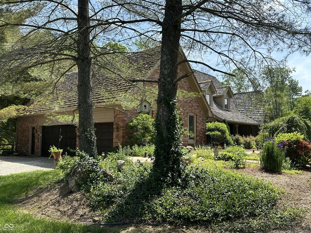 2034 Dubois Rd, Spencer, IN 47460 - view of front of house featuring brick siding, a garage, and driveway