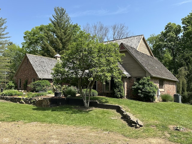 2034 Dubois Rd, Spencer, IN 47460 - view of front of house featuring brick siding, a front lawn, and central AC
