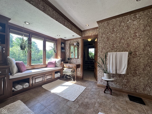 2034 Dubois Rd, Spencer, IN 47460 - living room featuring ornamental molding, a textured ceiling, baseboards, wallpapered walls, and healthy amount of natural light