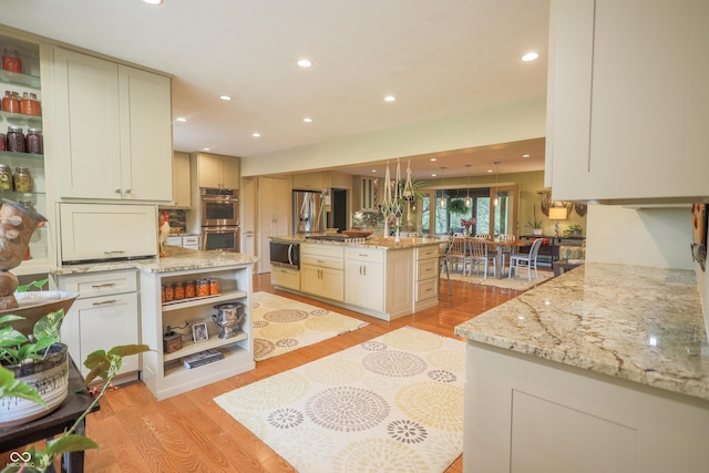 2034 Dubois Rd, Spencer, IN 47460 - kitchen with stainless steel appliances, open shelves, light stone counters, light wood-type flooring, and recessed lighting