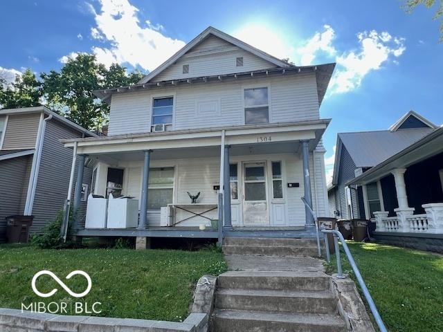 1304 Franklin St, Columbus, IN 47201 - american foursquare style home featuring covered porch and a front lawn