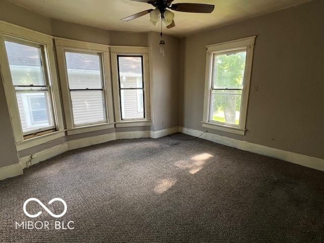 1304 Franklin St, Columbus, IN 47201 - empty room with baseboards, ceiling fan, and carpet floors